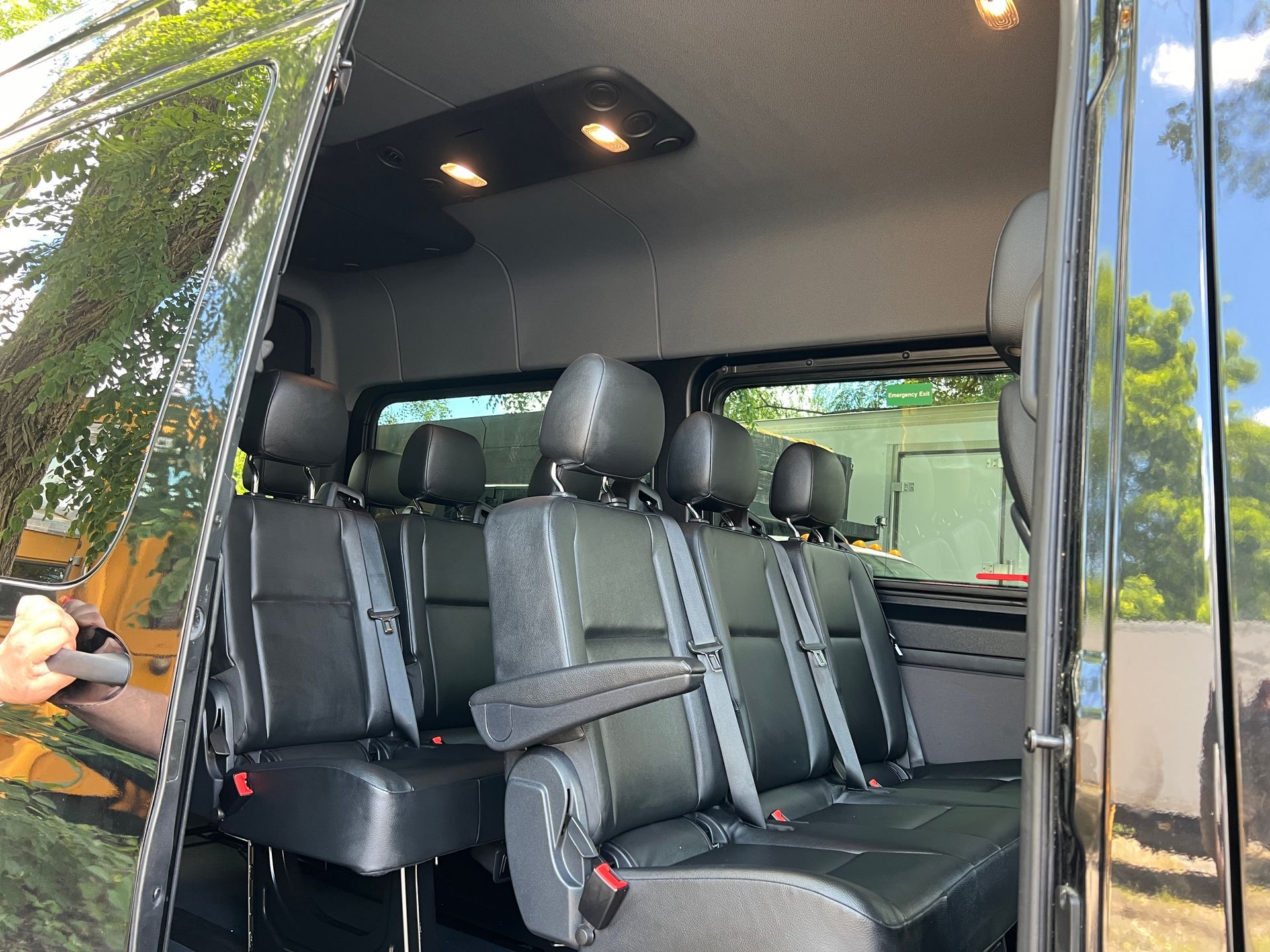 The inside of a van with a lot of seats and a window.