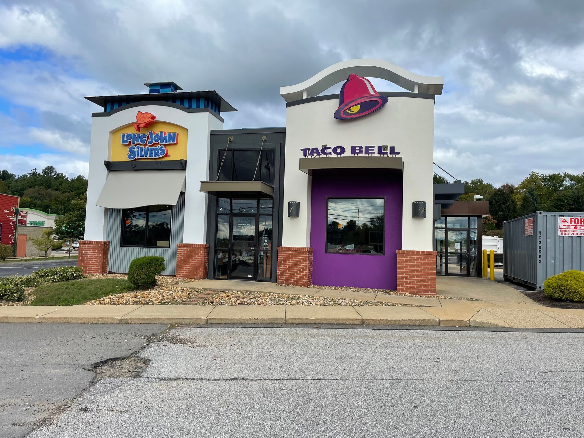 Taco Bell restaurant exterior with drive-thru windows and clear signage on a cloudy day