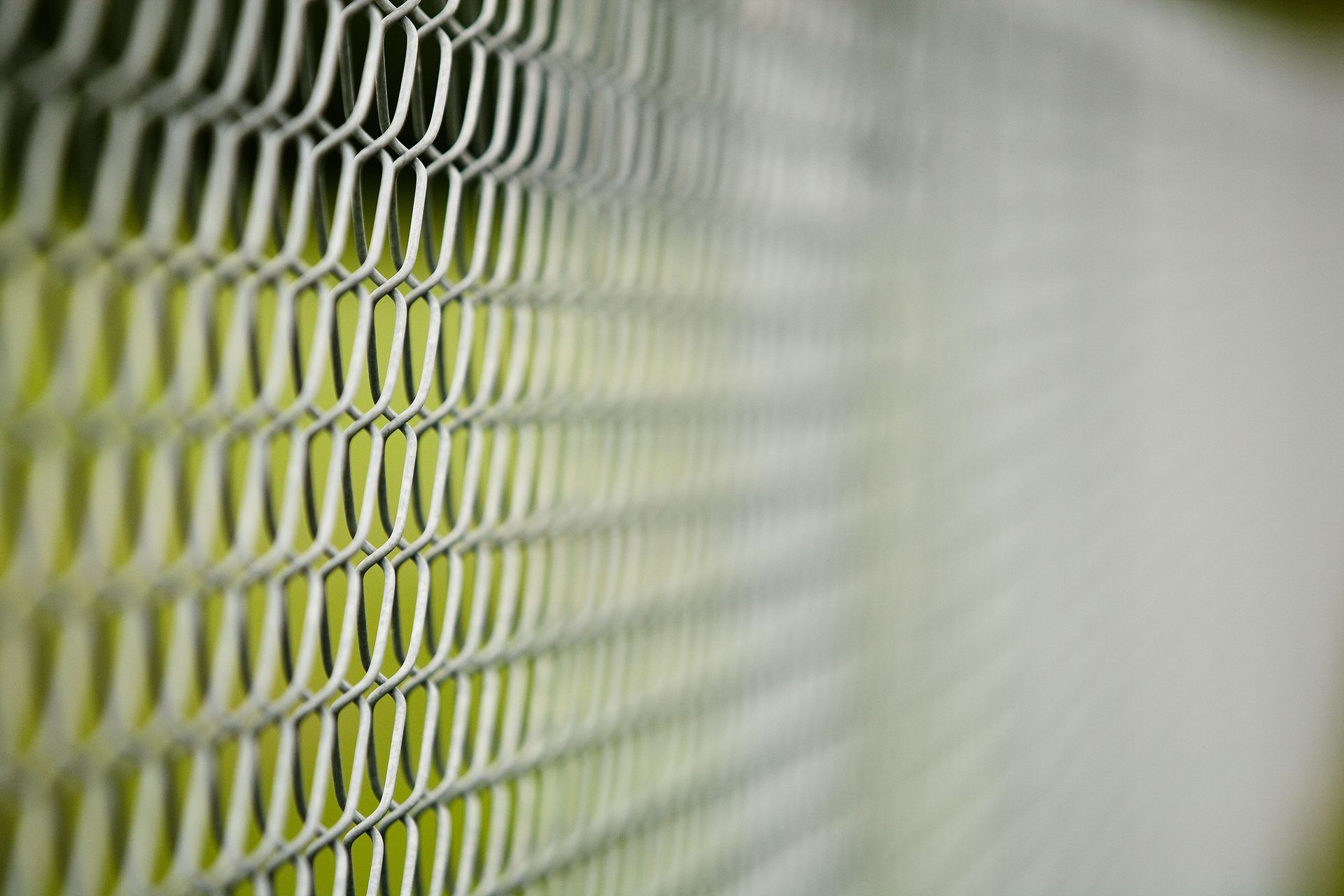 A close up of a metal fence with a pattern on it.