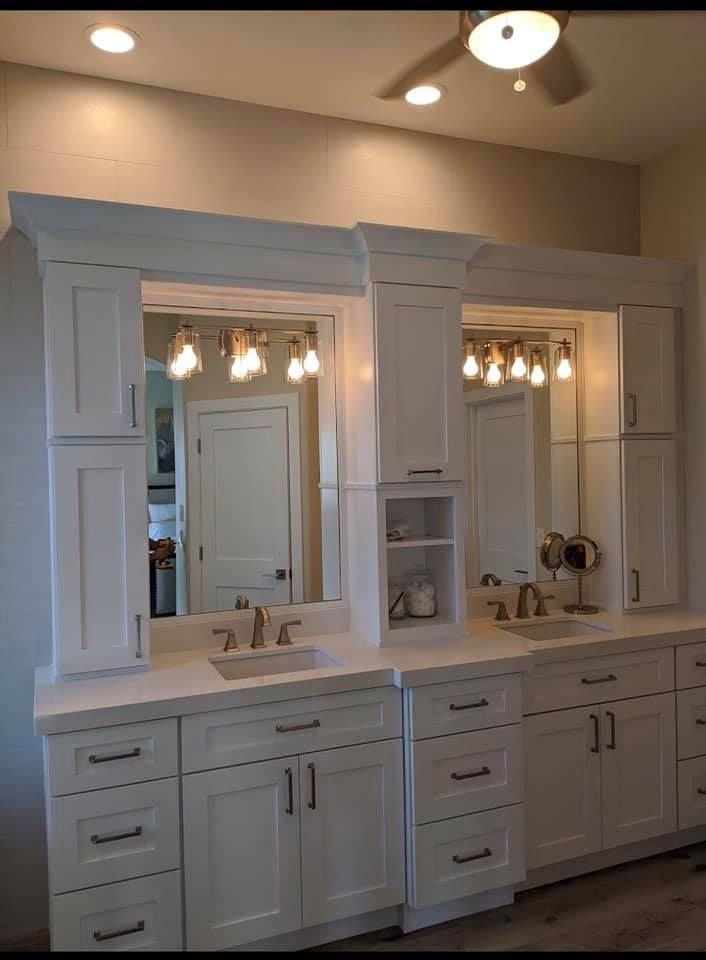 A bathroom with two sinks and two mirrors