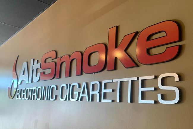 A sign on a wall that says salt smoke electronic cigarettes