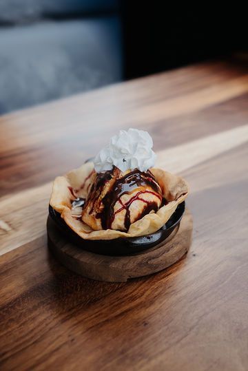 A close up of a dessert on a wooden table.