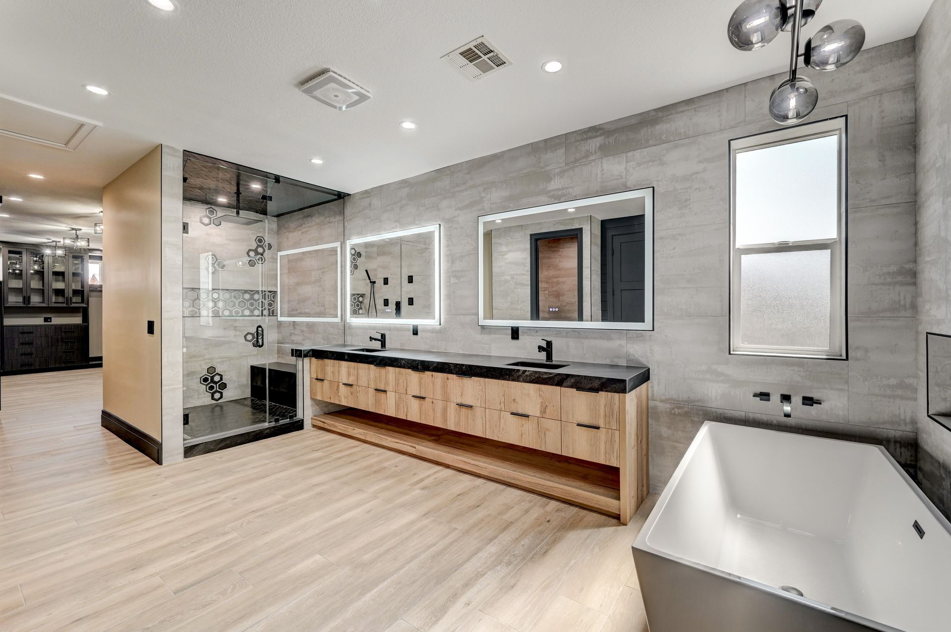 Modern bathroom with a double vanity, soaking tub, and walk-in shower.