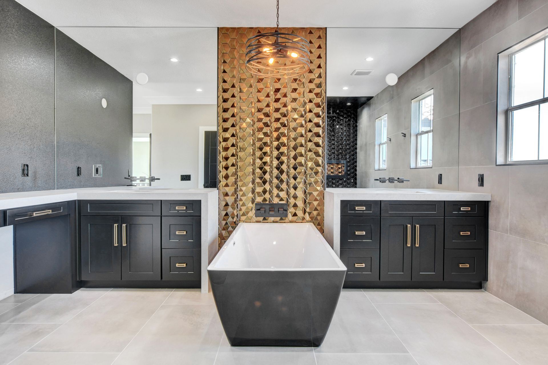 Luxurious modern bathroom with a gold accent wall, black cabinets, and a freestanding tub.