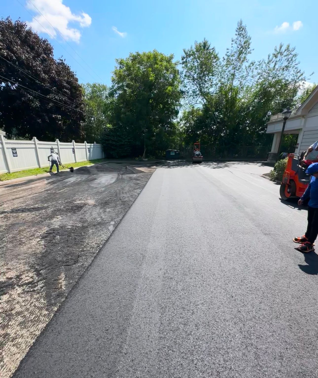 A group of people are standing on the side of a road