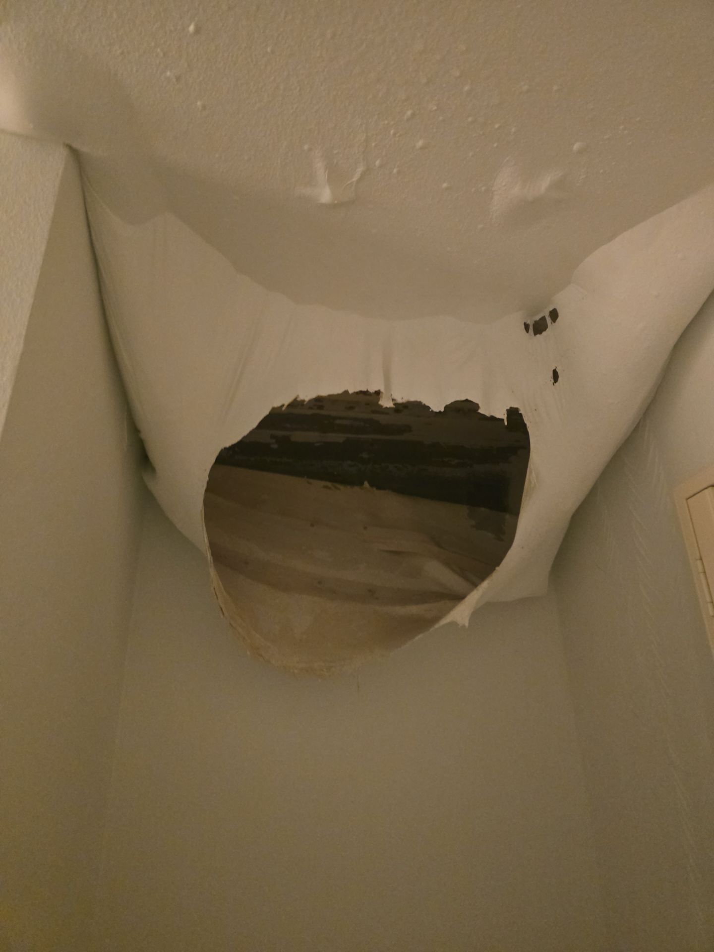 A light is shining through the ceiling of a room