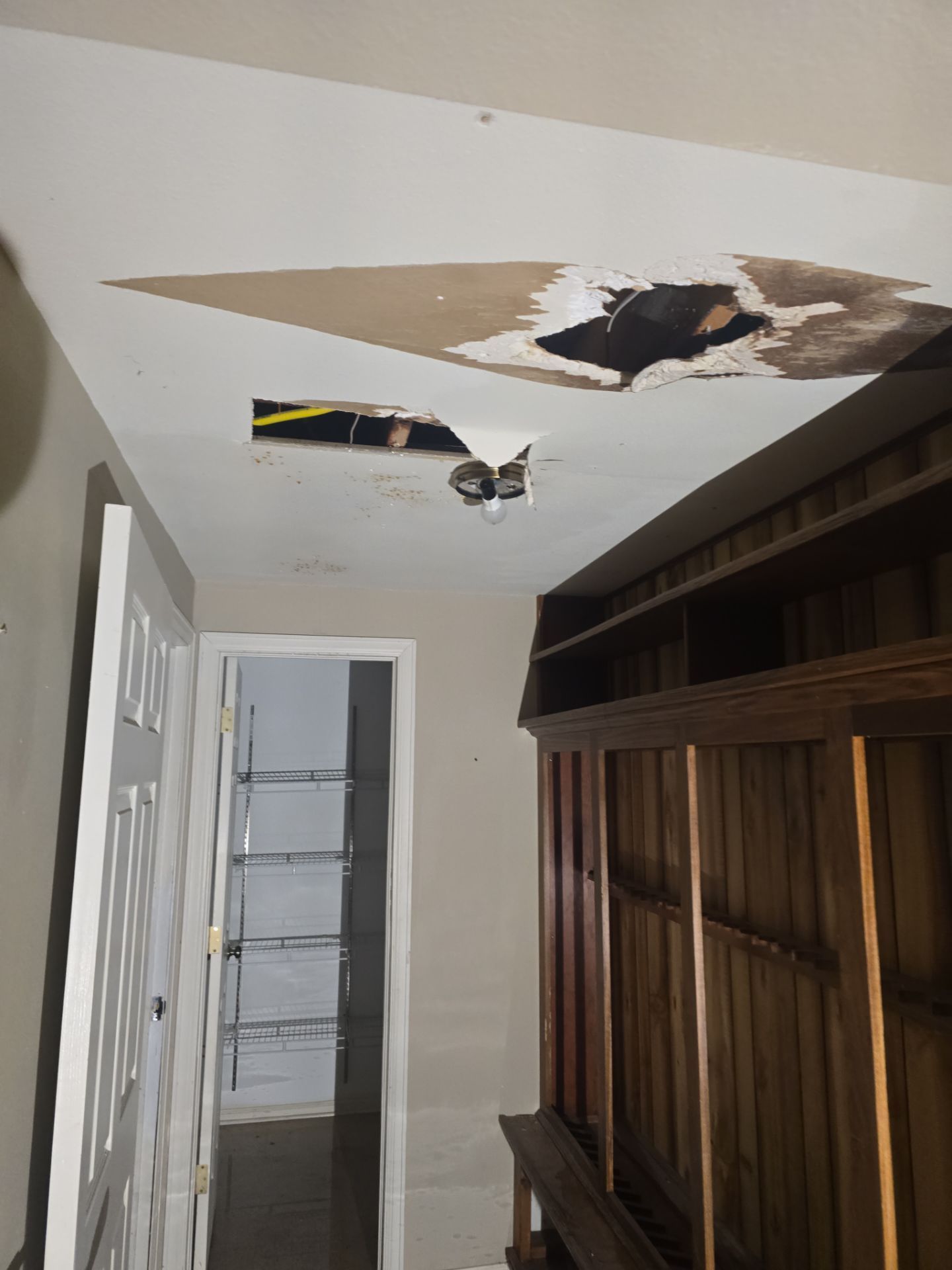 There is a hole in the ceiling in a hallway