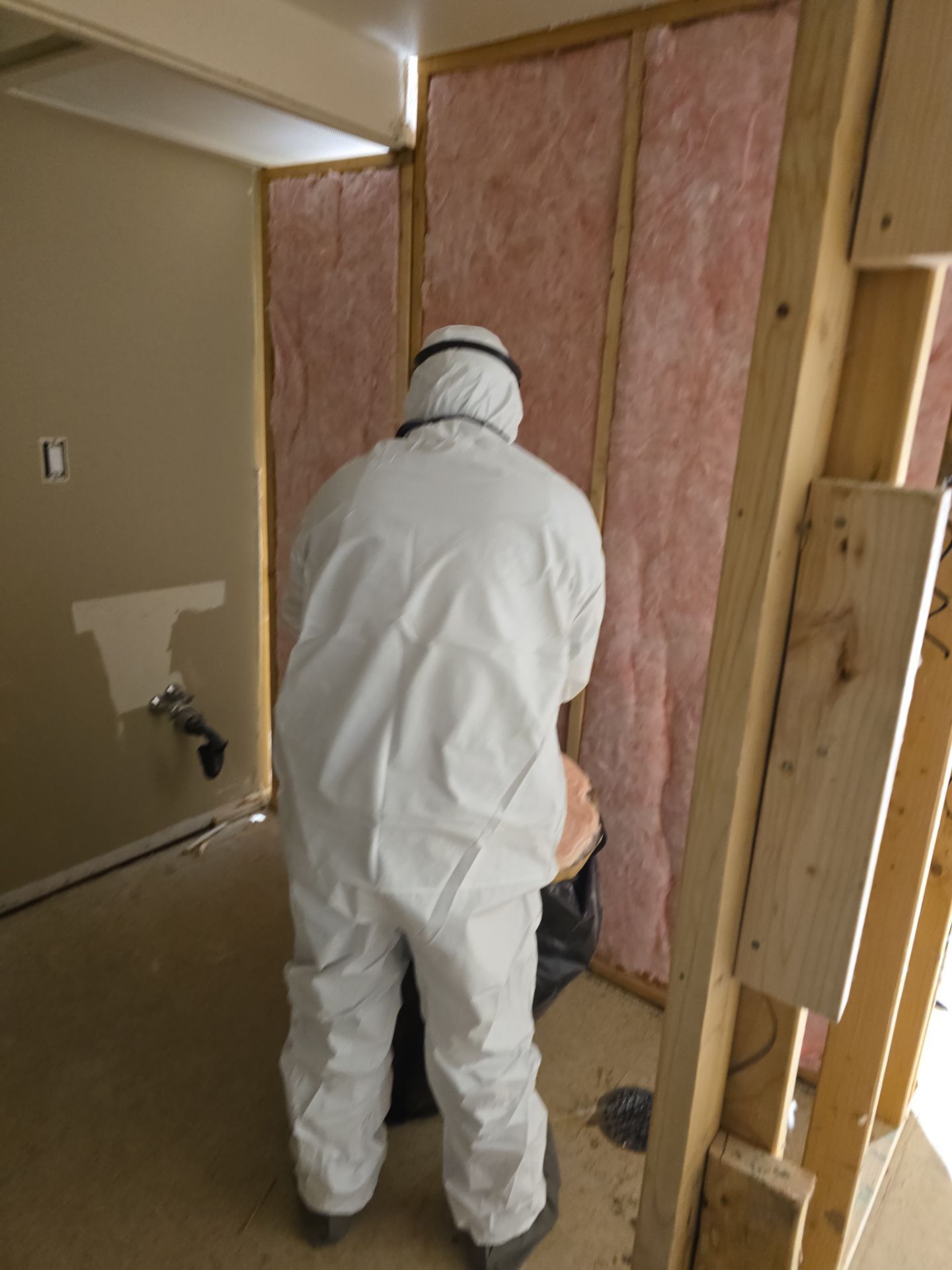 Man installing insulation to the wall