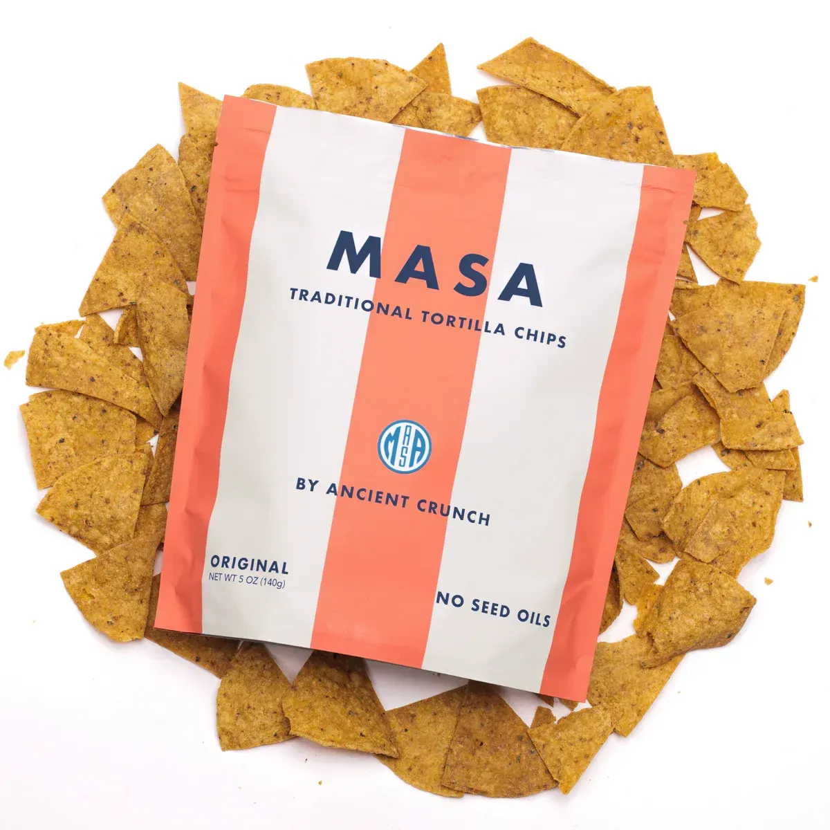 Bag of Masa tortilla chips on a bed of chips, with a white and orange striped package.
