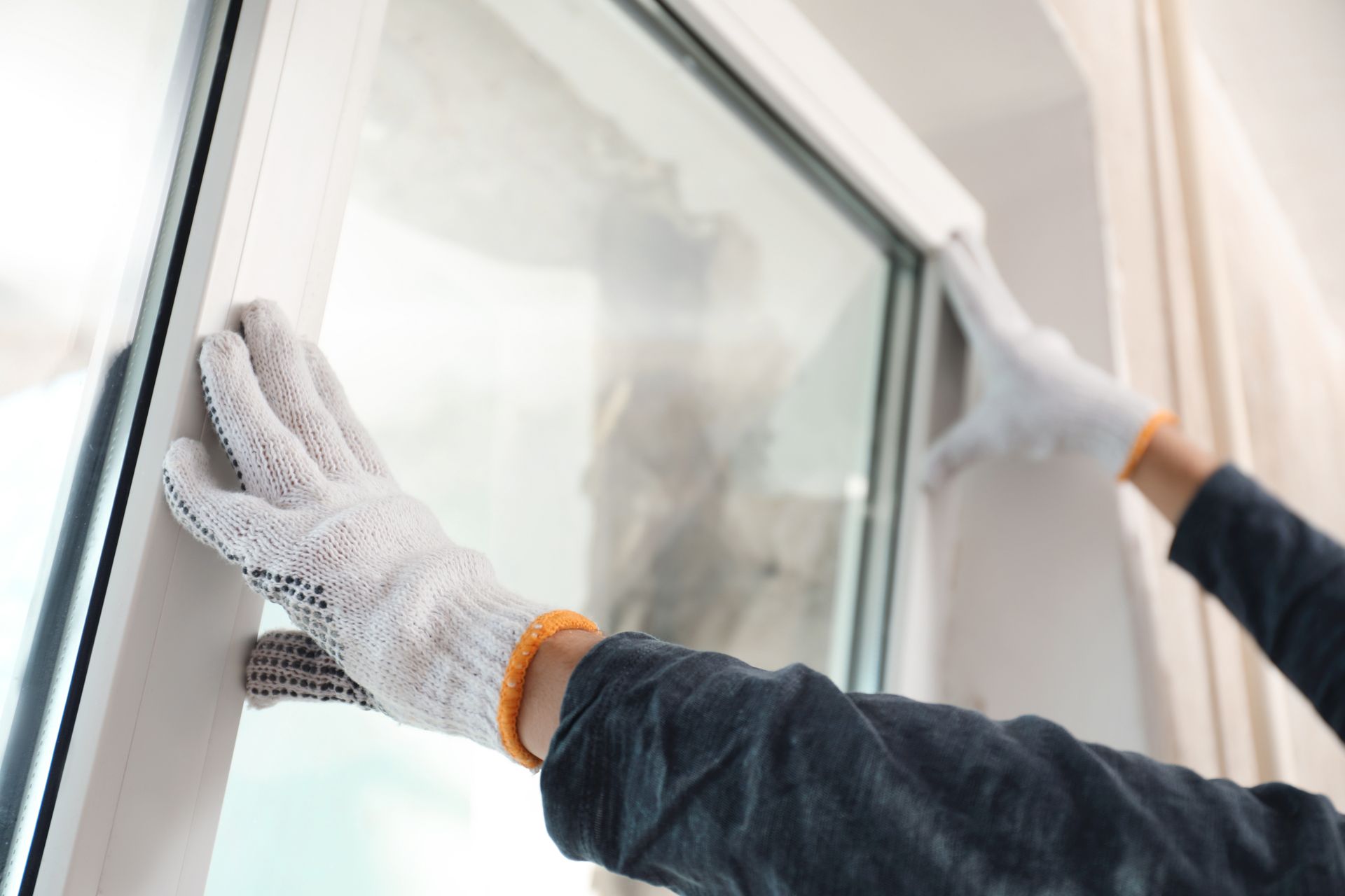 person replacing a window