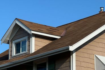 damaged shingles on a roof from storm damage