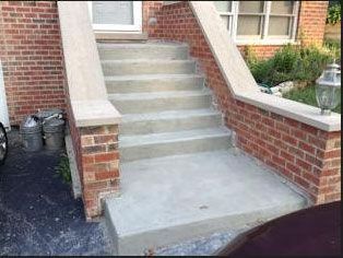 Brick steps leading to a front door, with brick walls on either side.
