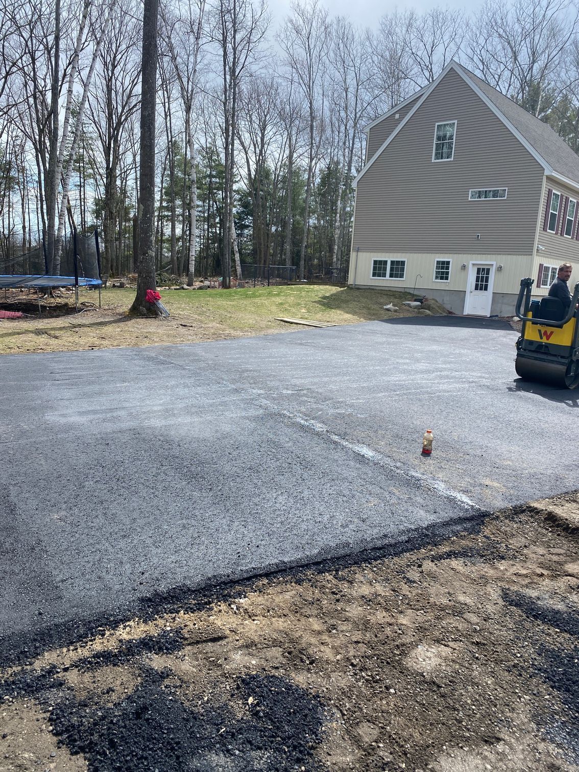A road is being paved in front of a house
