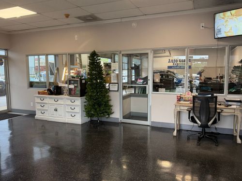 Lobby with Christmas tree, white desk, and computer workstation in a bright office space