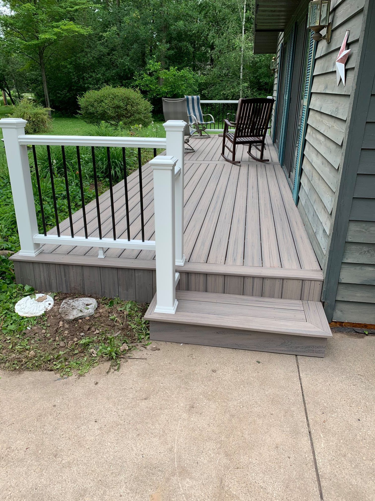 There is a porch with a rocking chair on it.
