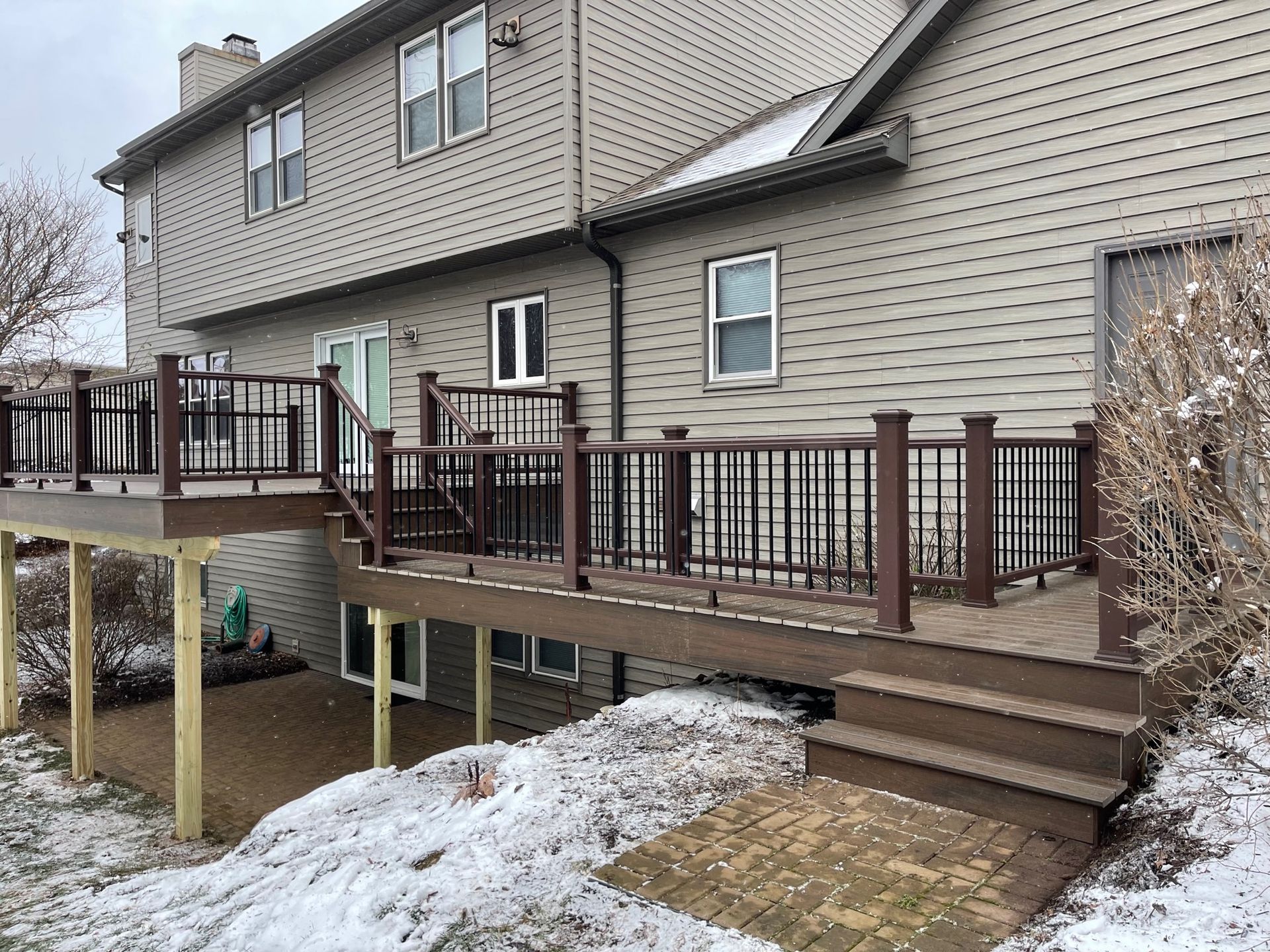 A large house with a large deck in front of it.