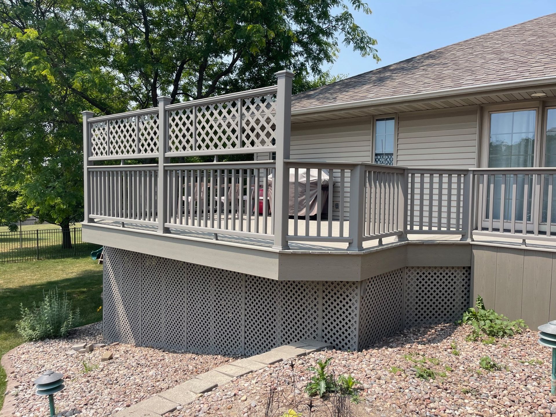 A house with a large deck on the side of it.