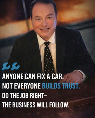 Smiling businessman in suit with text: “Anyone can fix a car. Not everyone builds trust.”