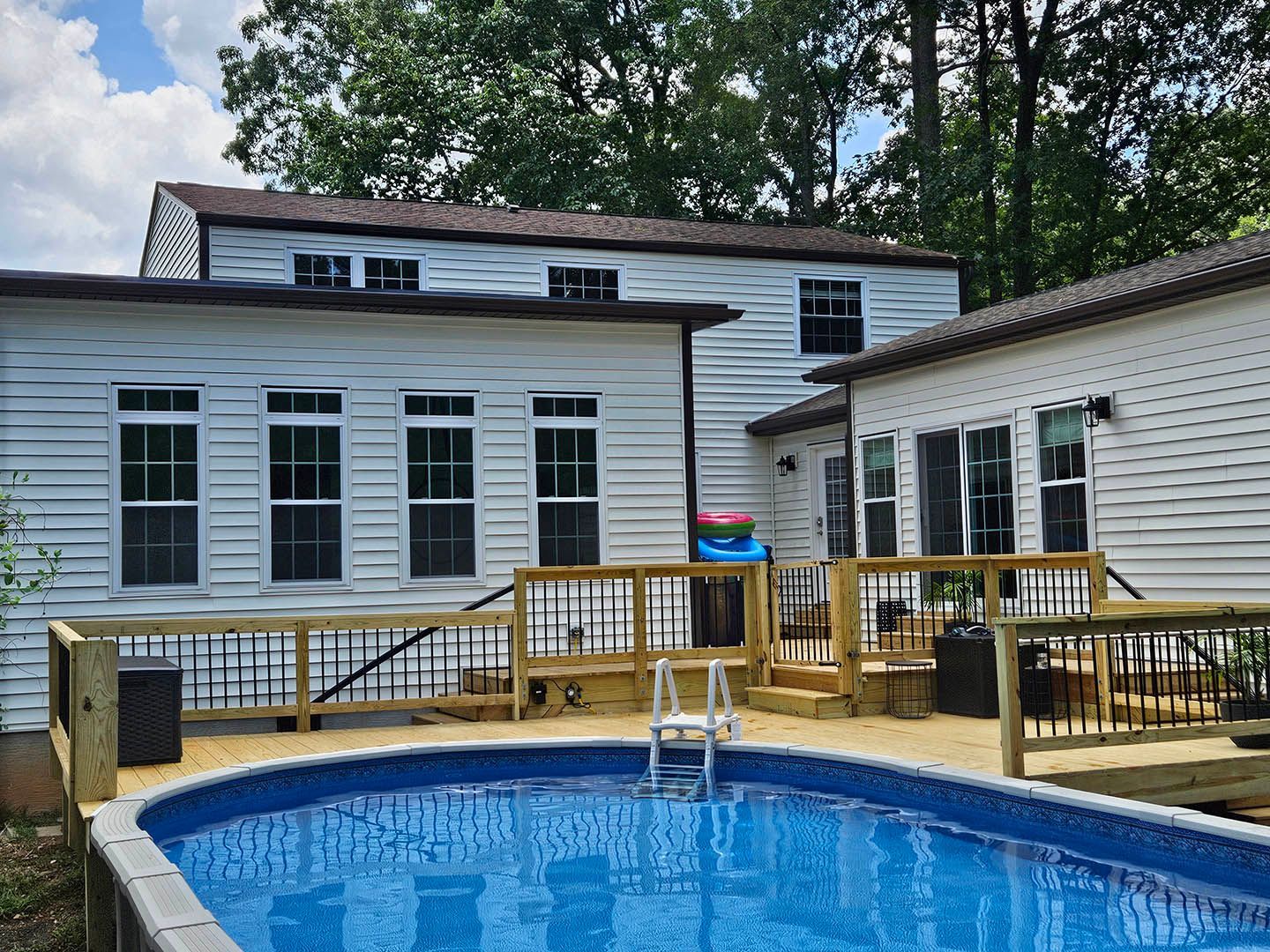 A large white house with a large swimming pool in front of it.
