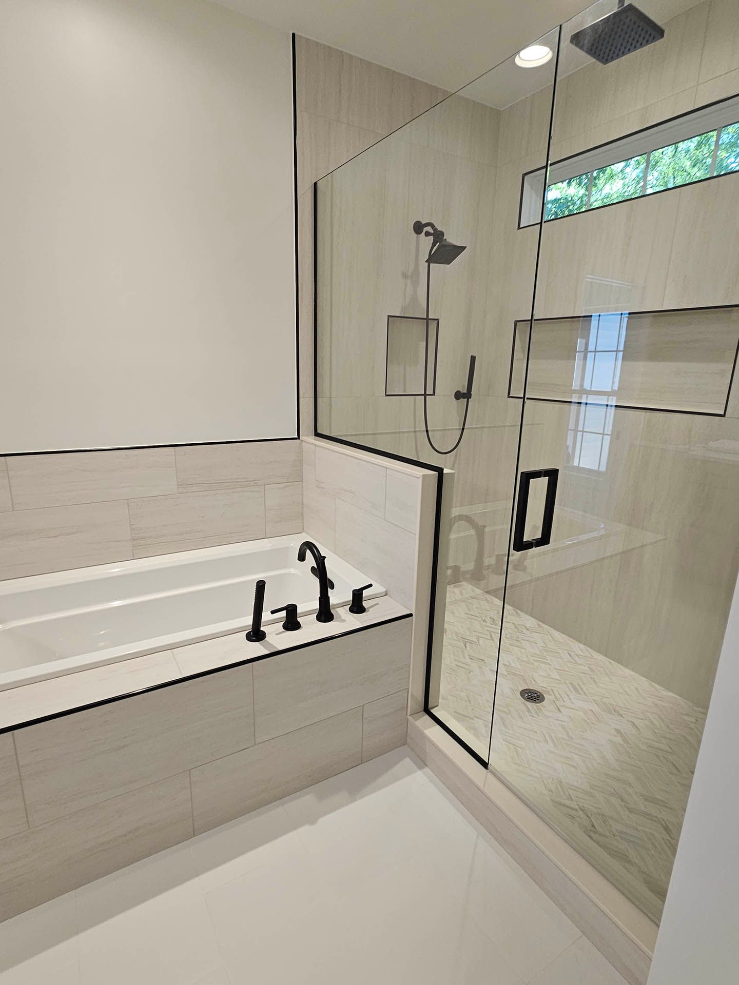 A bathroom with a bathtub and a walk in shower.