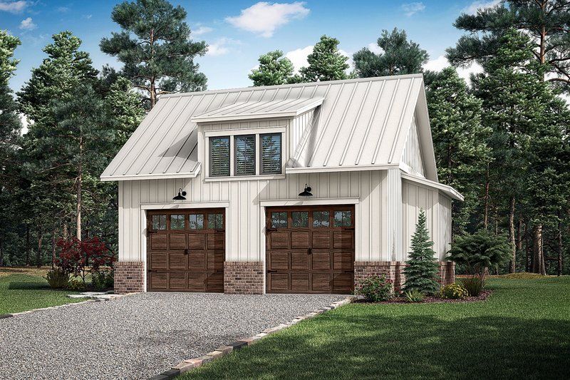 A white garage with two brown garage doors and a metal roof.