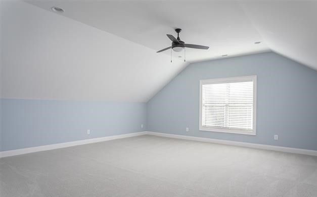 An empty room with a ceiling fan and a window