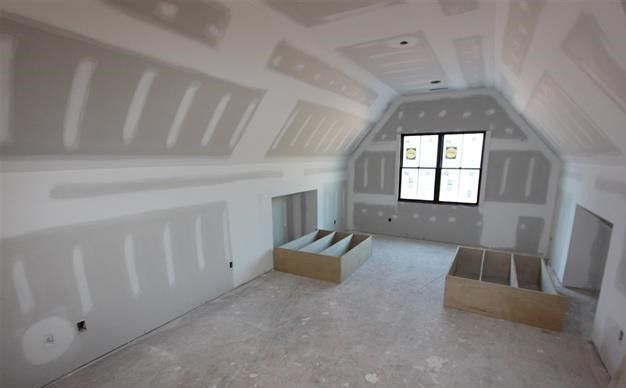 A room that is being remodeled with drywall on the walls