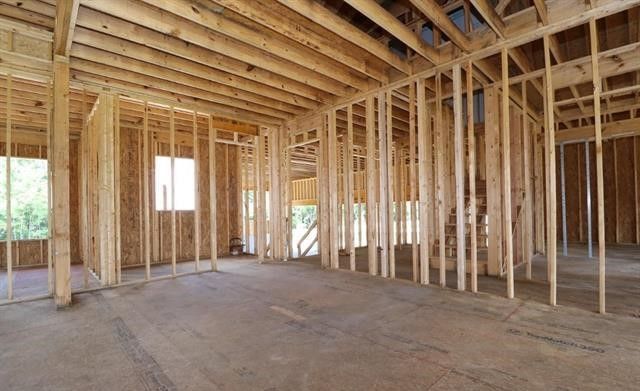 The inside of a house under construction with wooden beams.