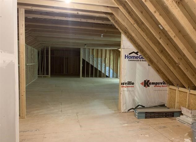 A room with a ceiling that is being built with a sheet of paper that says homeguard on it.