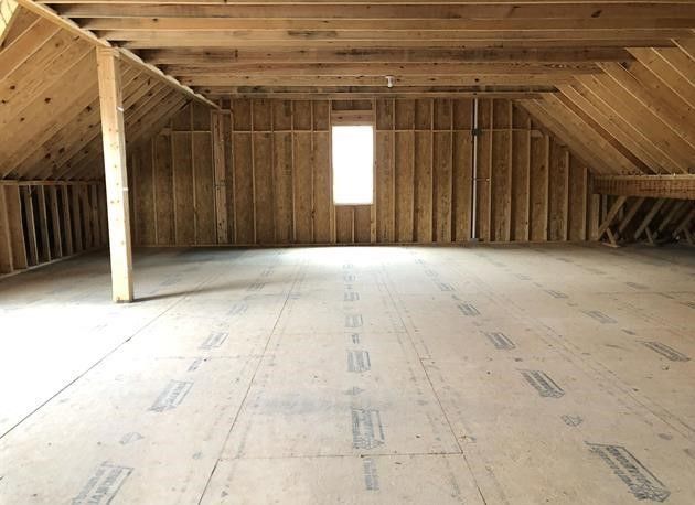 An empty attic with a window in it
