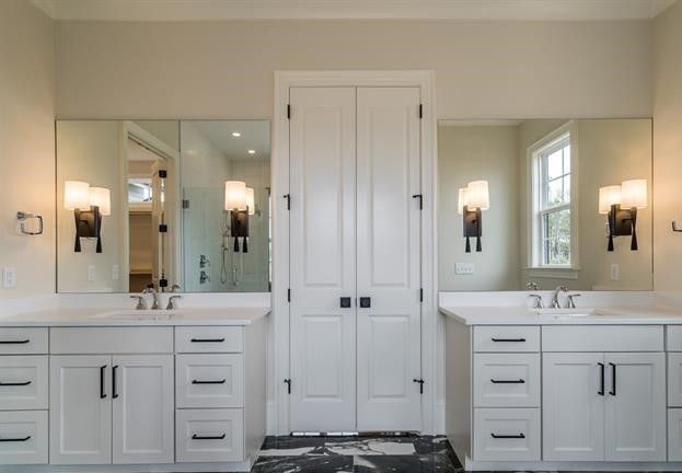 A bathroom with two sinks and two mirrors.