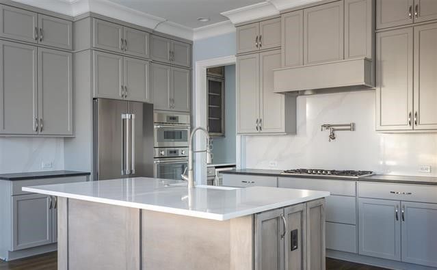 There is a large island in the middle of the kitchen.