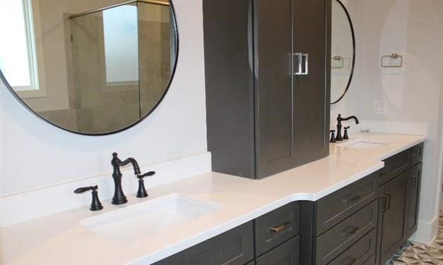 A bathroom with two sinks and two mirrors.