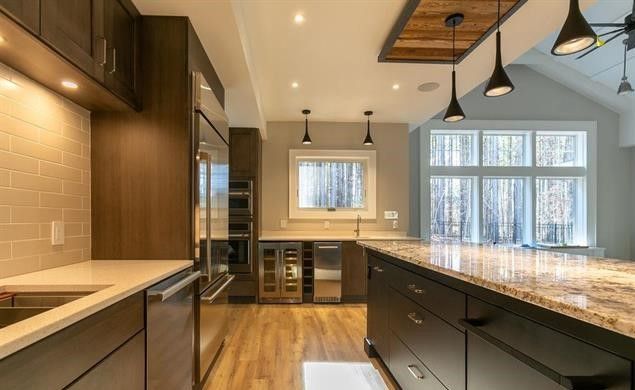 A kitchen with stainless steel appliances and granite counter tops.