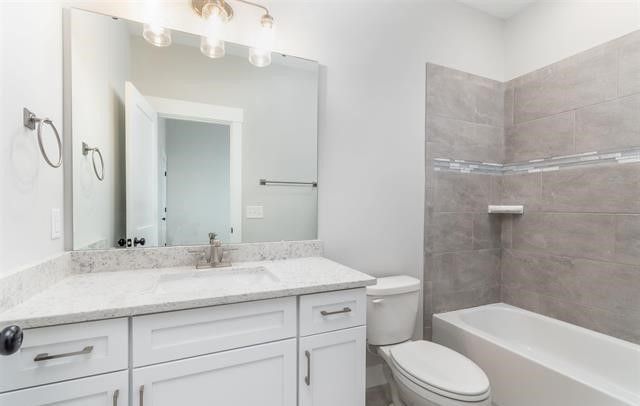 A bathroom with a sink , toilet , and bathtub.