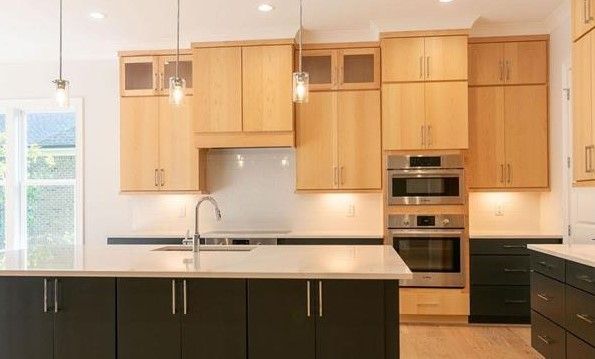 A kitchen with wooden cabinets and stainless steel appliances.