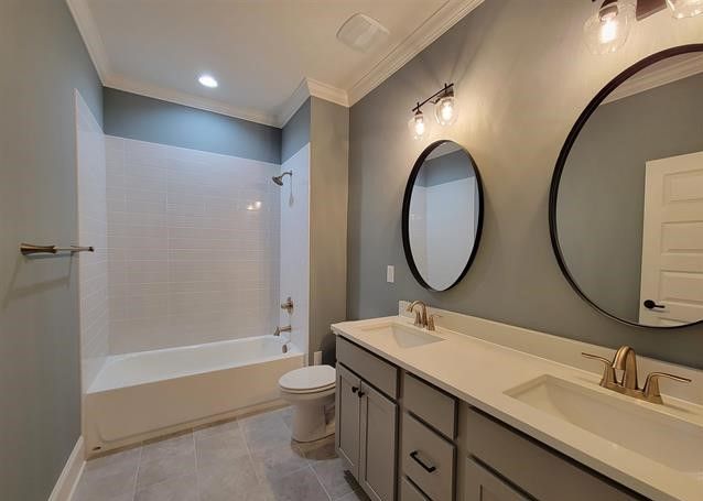 A bathroom with two sinks , a toilet , and a bathtub.