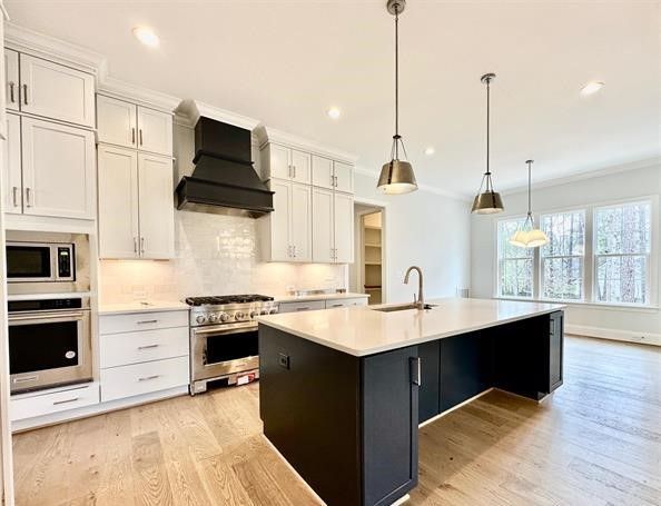A kitchen with a large island and white cabinets