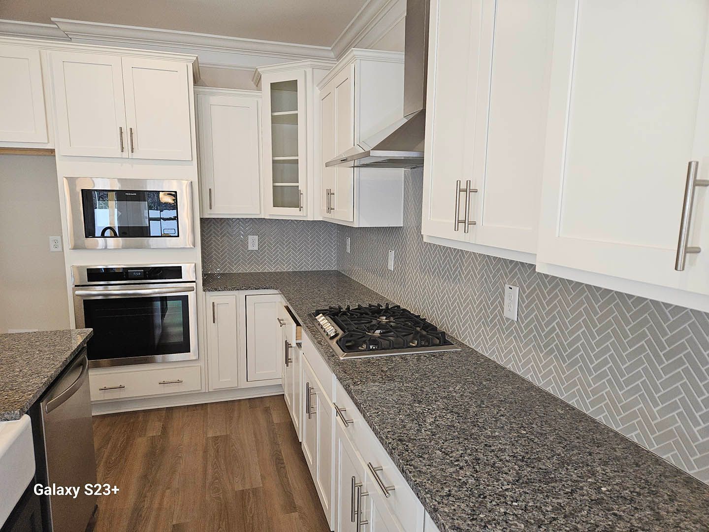 A kitchen with white cabinets and granite counter tops