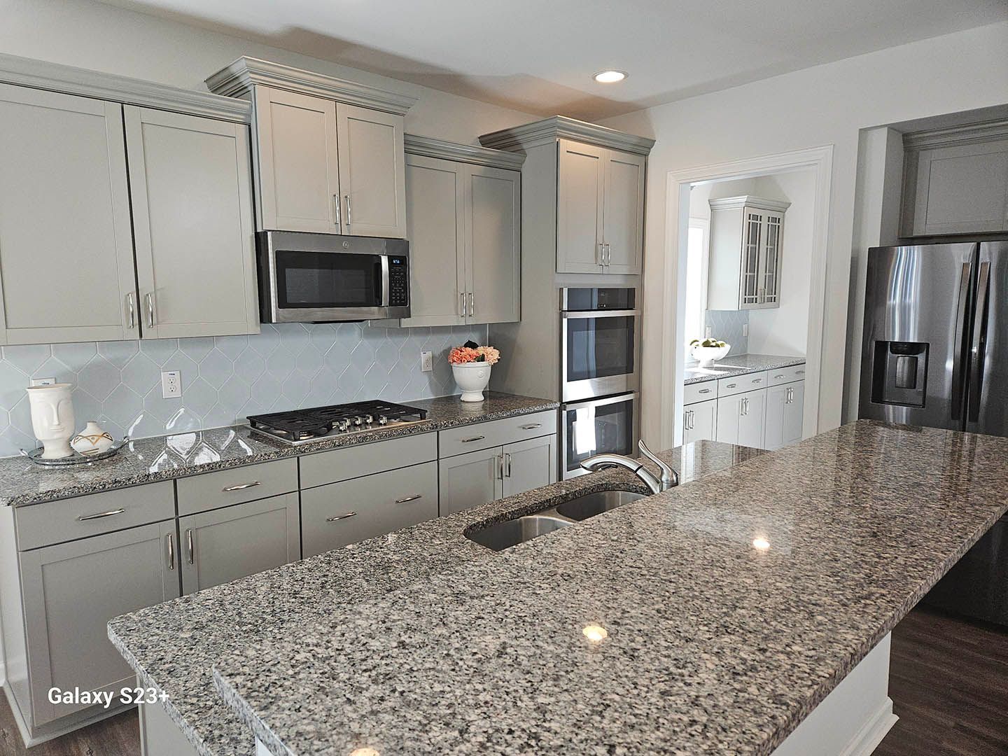A kitchen with granite counter tops and stainless steel appliances