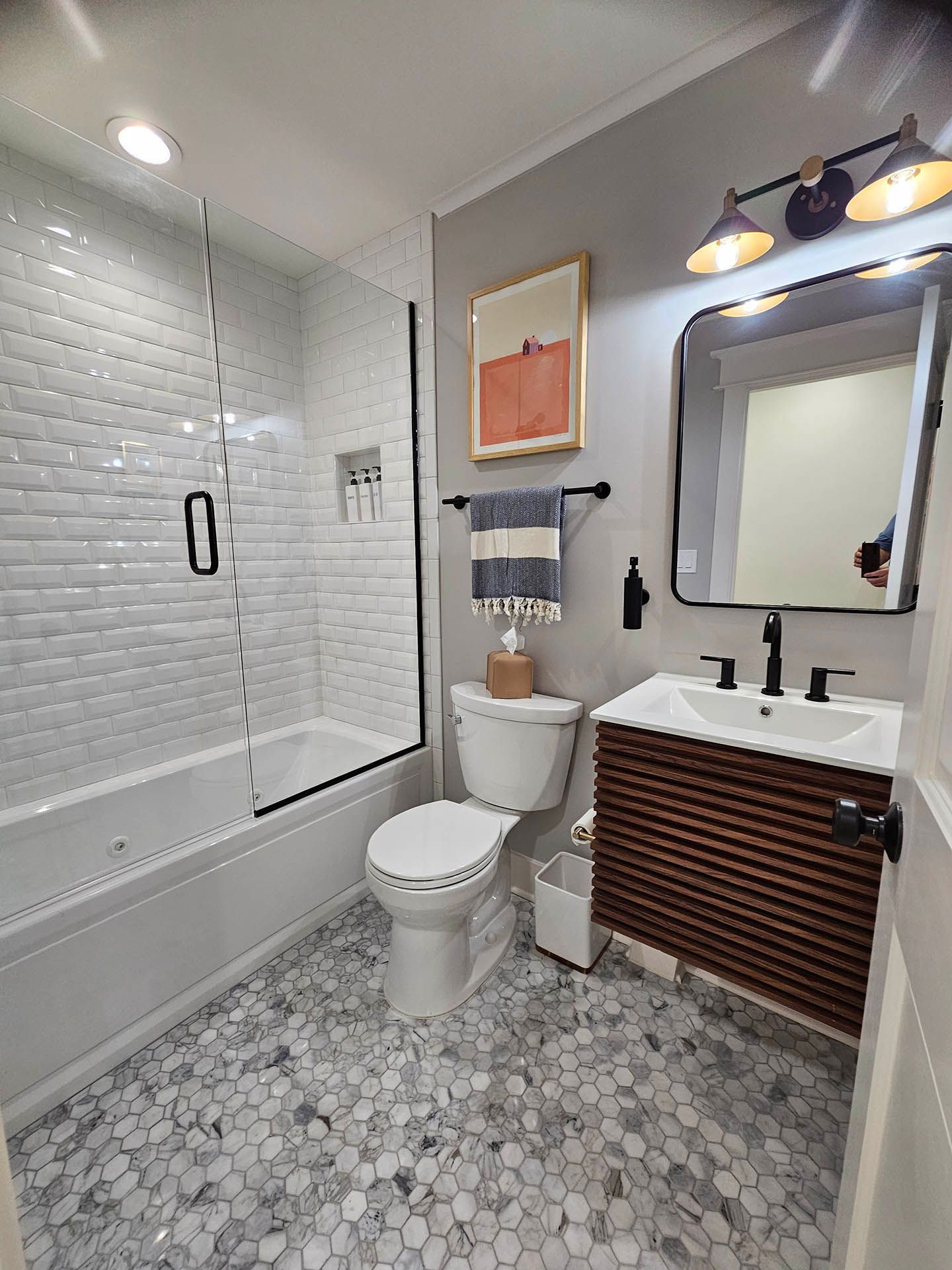A bathroom with a toilet , sink , and bathtub.