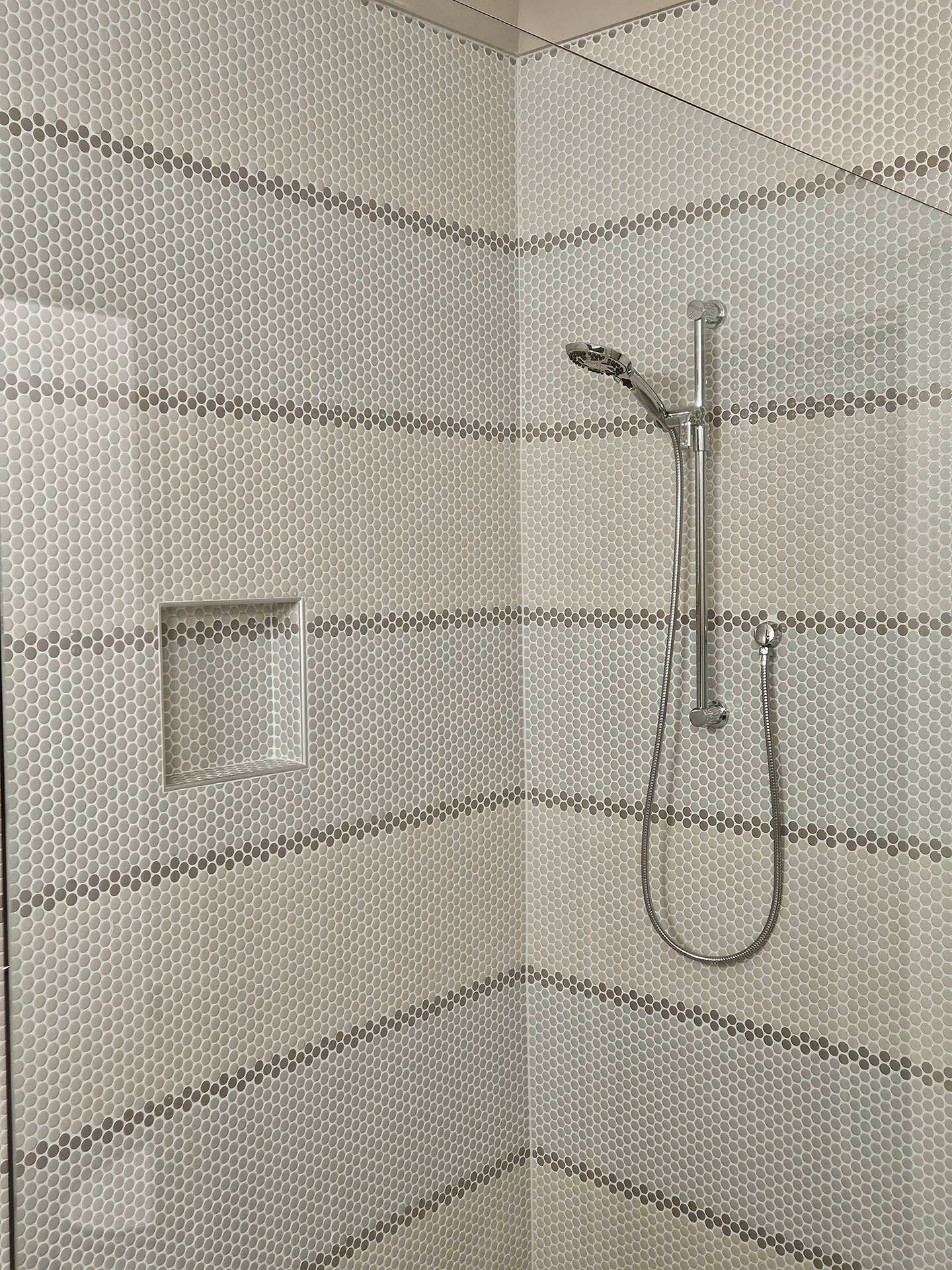A close up of a shower stall with a shower head.