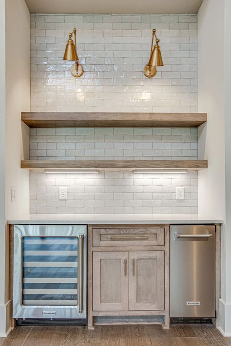 A kitchen with stainless steel appliances and a wine cooler.