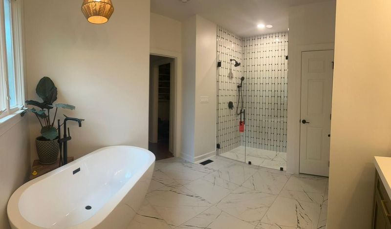 A bathroom with a bathtub and a walk in shower.