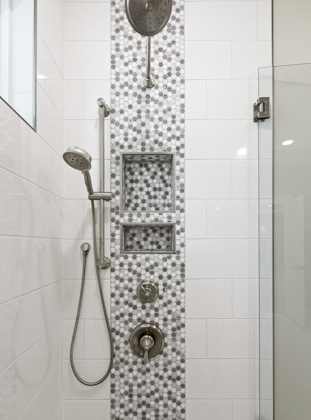 A shower with a shower head and a glass door.