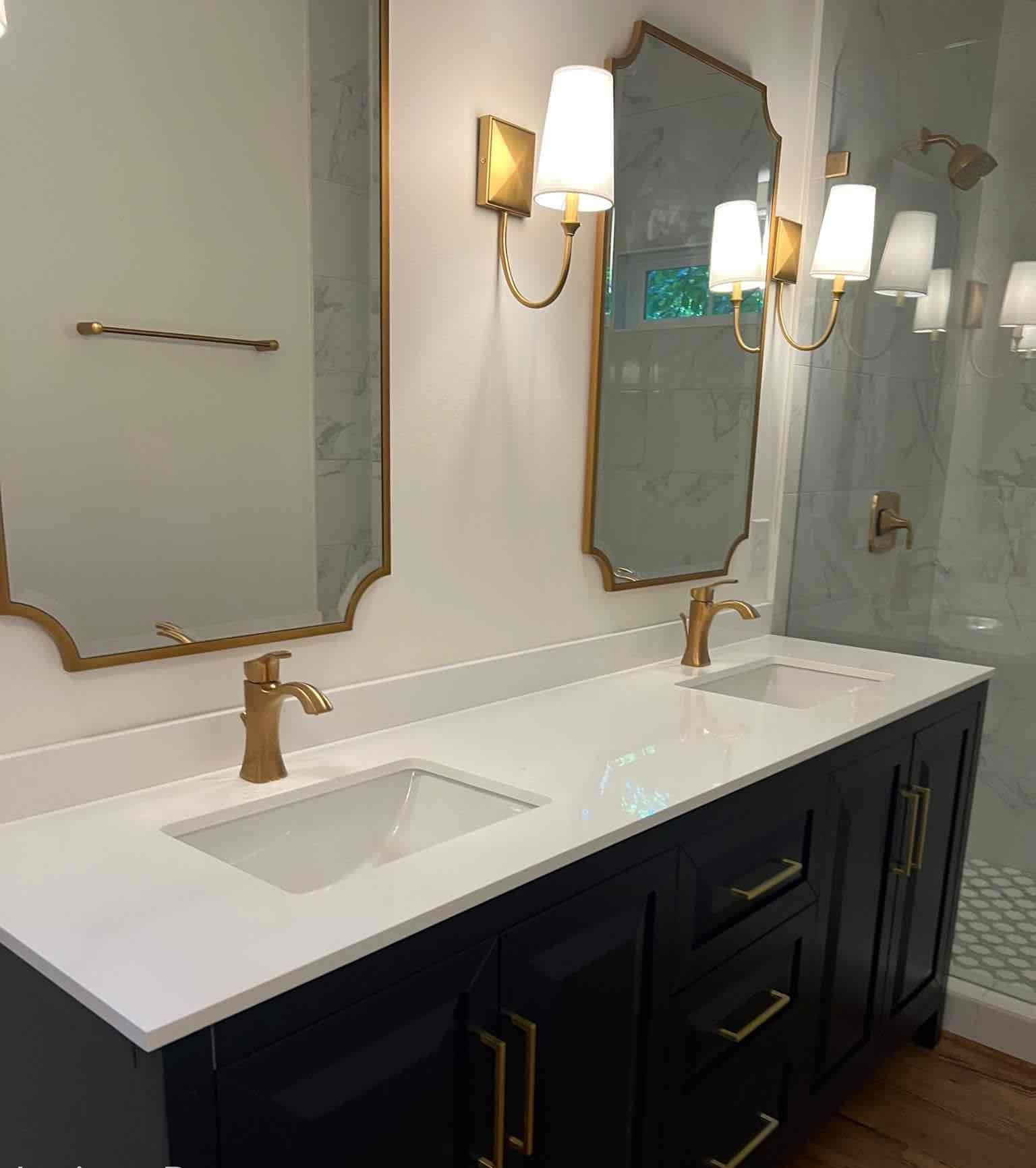 A bathroom with two sinks , two mirrors and a shower.