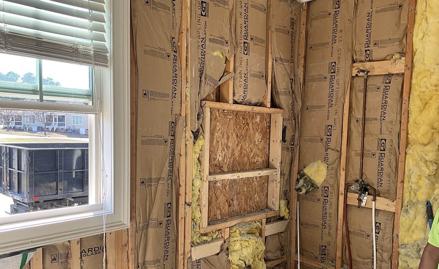 A room with a window and a ladder in it.