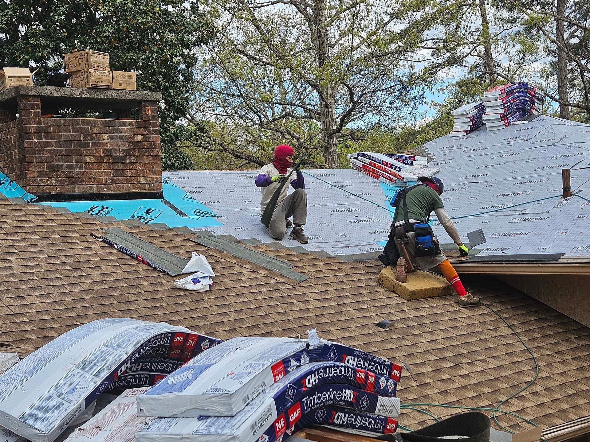 A group of men are working on a roof.