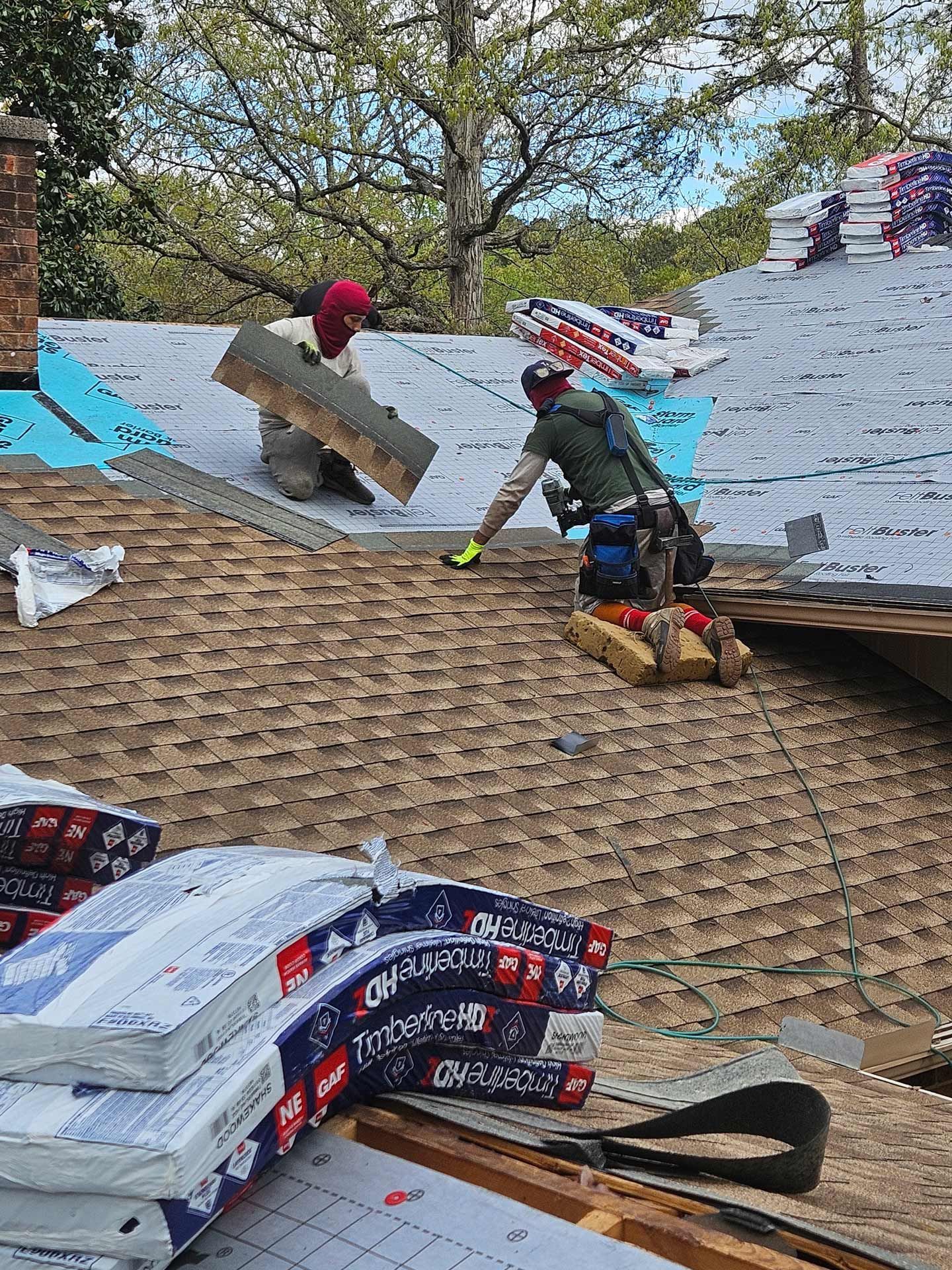 A couple of men are working on a roof.