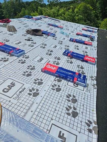 A roof with a lot of roofing materials on it.